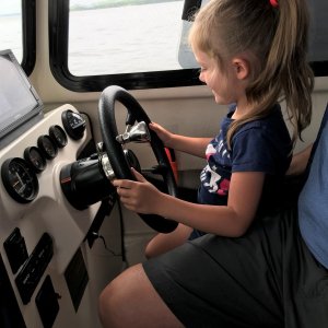 Captain Olivia at the helm (with a little help from Poppa)