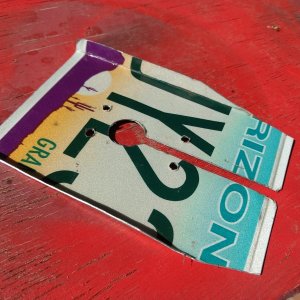 Transducer spray guard made from and old license plate