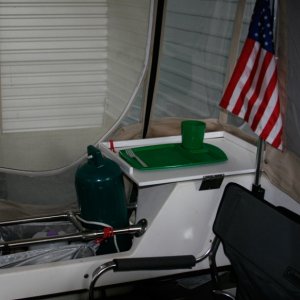 Fish cleaning / cutting board lives on the port lazarette and makes a handy surface to use while dining or using the CD bar. Stays put because it is captured by the camperback corner and grippy rubber under tray.