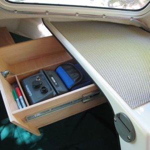 Locking storage drawer with angled front and compartments for GPS/binos/VHF, dividers/pens, other valuables.