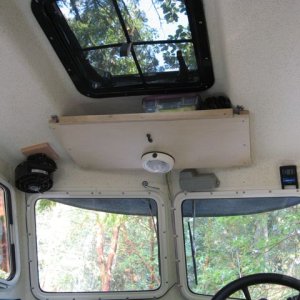 Media 'Overhead hatch with screen-- storage shelf forward. Red LED strip (less harsh for night use) installed to interior light circuit and OEM interior light moved forward (uses switch on light casing).' in album 'Anchor retainer using quick release pin to allow removal of anchor line from bow roller. Neoprene pad prevents scratches.'