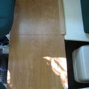 Bed extension (1/2 inch birch ply) resting on oak 1x2 on seat boxes; piano hinge allows unit to fold for storage.