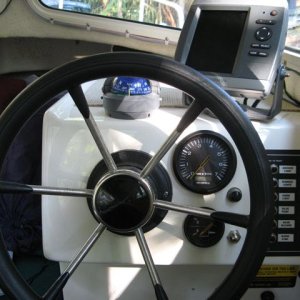 Instrument console: Ritchie Explorer compass, Garmin 545s GPS sounder, tach/ hour, tilt meter, horn button, intermittent wiper button, various electrical switches, 12 volt outlet facing downward under switch panel.