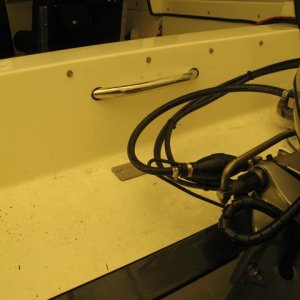 Stainless grab handle installed in well to assist boarding when standing on permatrim
