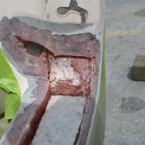 To the right of the previous photo.  We have put a piece of roving on the back side of the hole, to re-inforce the transom and splash pan.