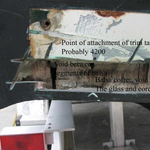 annotated void in the core at the transom.  This core in the bottom of the boat should be separated from the transom core by at least a layer of glass and should extend to the extreme end of the boat, so there is no voids, where water can trap.  The solution is to fill this gap with solid glass.
