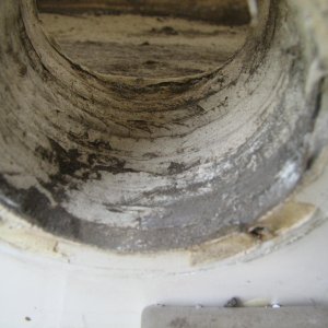 initial photo after the \"flapper\" valve is taken off.  There is gel coat smeared over the wood boring, and some voids.