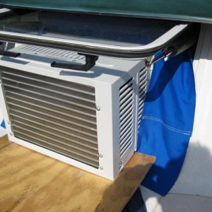 $ 89, 5,000 BTU AC unit in the opening window of CD 25.  Sunbrella snaped on the inside of the frame and draped over the sides to keep water out.