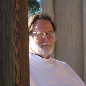 Bill hides behind a post