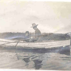 A skiff in Long Beach Harbor with CR Austin in a suit in 1907