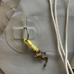 D Ring patch for rain fly over fore deck, Material is shelterRite and the patch is from Amazon, with a old jib hank and showing Dacron rope to tie the fly off to the Pulpit.