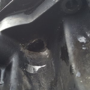 Media 'Quarter-sized corrosion hole underside of oil pan.  Notice the light gold colored replacement plug.  Didn't help.' in album 'New Garmin 18xHD Radar - April 2016'