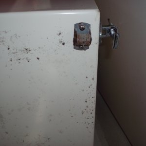 Bottom of chair shows roller caster and side bolt to attach to floor