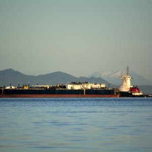A tanker barge and tug at the refinery