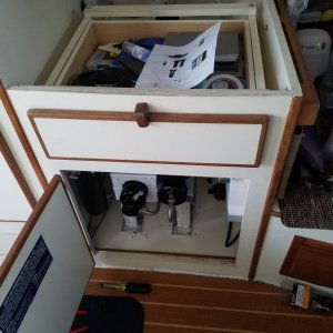 Media 'The cabinet previously used for the water heater. You can also see the teak cabinet access door I installed under the settee table.' in album 'Dana loading up the huge Spectra watermaker box.'
