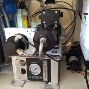 Media 'Almost finished, the flowmeter and pressure gauge were hard to find a convenient spot for. In the background you can see the copper foil that is the caries the ground plane from the SSB transceiver antenna tuner to the through hulls under the step where it is well bonded.' in album 'Dana loading up the huge Spectra watermaker box.'