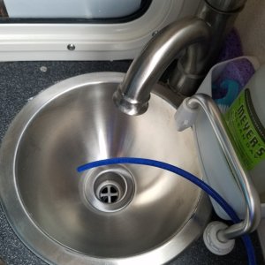 Media 'Finally finished with the watermaker! This is the blue test water outlet line. The initial output is tested for salinity until it has almost 0 salt before routing the drinkable water forward to the water tank.' in album 'Dana loading up the huge Spectra watermaker box.'