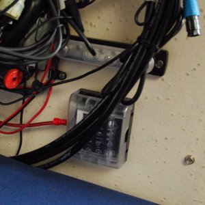 Media 'Sea Angel\'s Secondary AUX 6 ckt DC power block & 10x ground buss 2a. The rectanguliar 'bar' above the square Secondary AUX DC power panel is a 10X #8-32 negative ground buss bar. It has a plastic removeable protective push on cover. It is strapped to the main 12 ckt MAIN AUX Negative ground stud post with a copper link. 
The black "cables" laying above the power blocks are the steering's hydraulic lines.' in album 'Sea Angel\'s Secondary AUX 6 ckt DC power block & 10x ground buss 1. The square block is the 12VDC Secondary AUX 12 VDC ATC fuse holder type Power Panel without ground strips and quick connect 'tabs' for the loads. 
The other end of red lead is connected to the 12VDC input connection (stud) of the Main Aux, 12 ckt  fuse panel w/ ground strips.'
