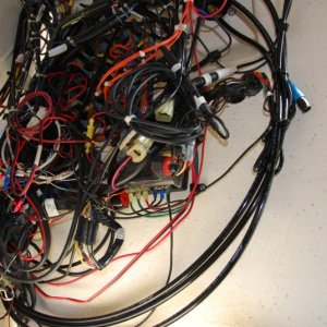 Media 'Sea Angel's (2012-12-14) Before installation view for the power distribution expansion. Such a wiring mess to refine and work with. I hope to unroll all those cables and either resize or relocated. The 2 engine harness cables will be the most challenging.' in album 'Sea Angel\'s Secondary AUX 6 ckt DC power block & 10x ground buss 1. The square block is the 12VDC Secondary AUX 12 VDC ATC fuse holder type Power Panel without ground strips and quick connect 'tabs' for the loads. 
The other end of red lead is connected to the 12VDC input connection (stud) of the Main Aux, 12 ckt  fuse panel w/ ground strips.'