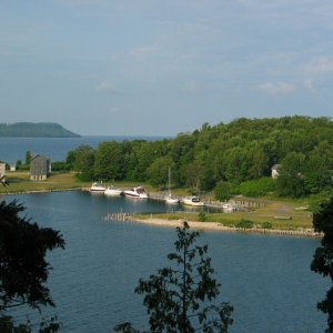 Snail Shell Harbor Fayette MI. One of the best destinations on the Great Lakes. Nice park, nice history, nice walking, great views, NO shopping. Jointly run by DNR and Historical Commission, good dockage, no electric or services. Water and pit toilets 50 to 110 yards away.