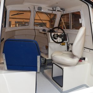 The original seats were Sunbrella over flat foam over a piece of plywood.  After a few years, they feel like Sunbrella over plywood.  The widest part of the original seats was at the aluminum hinge right at the bottom, causing my pilot seat to interfere with the throttle when I rotated the seat.