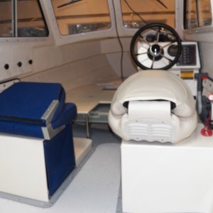 Media 'Both seats fold down, but here you can get an idea of how the Attwood seat is narrow at the "corners," i.e., right where it needs to be in order to miss the controls.  No sharp hinge edges now.  You can also see that it sits several inches higher because it has an internal 3" spring suspension.' in album 'The original seats were Sunbrella over flat foam over a piece of plywood.  After a few years, they feel like Sunbrella over plywood.  The widest part of the original seats was at the aluminum hinge right at the bottom, causing my pilot seat to interfere with the throttle when I rotated the seat.'