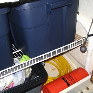Coated wire shelving, flipped upside down and angled back toward the hull - 18 months old and no rust (yet?)