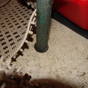 It rests in a rubber plug. Not bolted to floor.