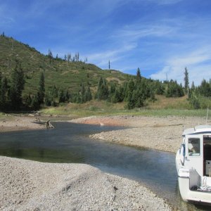 A stern breeze causes Mike to get the "Little Joe" sideways in a small creek on the west side of Jackson Lake
