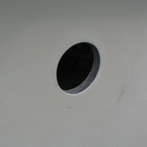 After enlarging to new size - used Dremel with sanding drum, sanded to pencil line.  I taped a plastic bag around the hole on the inside to keep dust out of the boat, and also had a vacuum nozzle taped to the topsides on the outside where I was working.