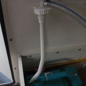 The dip tube is a ~2 foot section of 1/2" PVC water pipe.  I heated it up with a heat gun and bent it to shape so it would get into the lowest corner of the tanks. It just friction fits into the fitting above it.