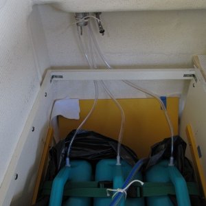 Media 'Ran hoses up to currently unused water fill (just to have a place to gather them, nothing to do with the fill in particular), and then with a piece o string tied them in place.  The hose compresses slightly so stays there. I also decided to put the jugs into a contractor bag just as a sort of liner in case there are drips when I'm filling or etc.' in album 'fill removed, dry core'