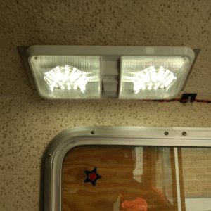 Our old '89 only has a light above the cockpit door and in the v-berth. Both have been changed to red LED since they don't attract bugs. Added this one above the galley for the times we need real light. It's only stuck up there with 3M tape until I'm sure that's where it's going to stay.