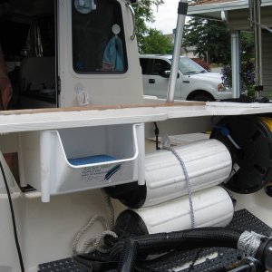 splashwell table stores 2 extra fenders, stern line and small locker.  All attached to table no holes.  Bungee to splashwell front  Off in no time if needed.