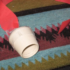detail of fume preventor.  7/8 rubber chair tip with red streamer taped to it for visibility fits over center of fuel vent and closes off against sides to prevent fumes around bbq and cockpit stoves on hot days