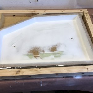 Media 'The mold for the port lid top is ready for laying up with 1708 and epoxy. There are several 1/2" holes in the bottom of this mold which are filled with wax. This gives a means to tap on the back of the mold with a 1/2" dowel to help pop the part free.' in album 'I'm modifying each lazarette to hold a 5 gal. horizontal propane tank. Starboard tank for heater and stove. Port tank for BBQ. Problem: Existing lockers are too small. Solution: Make them bigger. This means not just the interior of the locker, but the opening as well. I also wanted the opening to match the profile of the original hatch opening so, although it will look a little different from the original, it won't look like it wasn't part of the original design. I started with a mockup of the enlarged interior to make sure everything needed to meet ABYC guidelines will fit inside.'