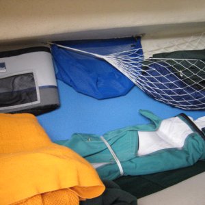V berth area storage bags sheet bags and hamock, with foam pads on the hull side and side curtains of enclosure