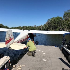 Colby helping the float plane off the dock.