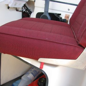 Chair Stop -- In action. The rubber coated stop prevents the chair from turning excessively, stopping the back of the seat from damaging the engine throttle assembly.