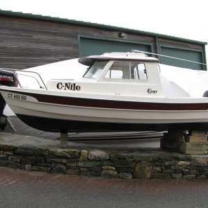 Media 'C-Nile on Blocks after Hull was painted' in album 'C-Dory 16 Cruiser with Suzuki 40HP 4-Stroke and Yamaha 4HP 4-Stroke Kicker -- Stern view showing security cable placement for kicker'