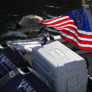 Combine these makings for a fine evening.  Yacht ensign on the back of a CD; a little power to get out on the water; a cooler with some staples; and a grill to fix it with.