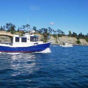 Mac on the "Island Ranger" headed into Fisherman's Bay, Lopez for opening weekend CBGT 07. Somebody in the far C-Dory is shooting back at us.  Wish we had a copy of that shot.