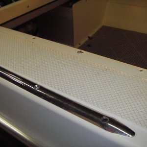 Stainless protection plate on gunnel at point above step into cockpit.  It was chipping the jel coat, breaking it where the screws were.