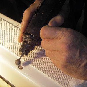 Grinding out cracks and chips in the Gel Coat from where the SS strip screws did not hold.