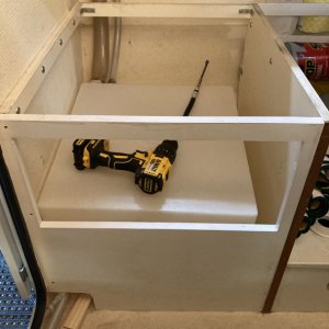 07 I had to prop up the tank to get to those pesky L-brakets (I also enlarged the access hole on the bottom left corner of the panel for better hose clamp access