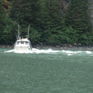 Discovery runing up the incoming flood tide at the entrance bar to Fords Terror inlet