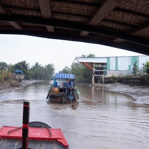 We followed this boat through a narrow canal at low tide, staying back far enough not to get sprayed when he had to lift his prop.  His discharge water would vary in color from light chocolate to dark chocolate depending on the amount of mud in the cooling water.