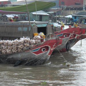 Media 'Bags of some kind of root crop.  Most boats had something hoisted on a mast that identified their wares.  I couldn't figure this one out.' in album 'The Mekong has been used commercially for centuries and it shows.'