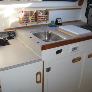 Media 'with backrest removed & seat cushing being used as cushion on ice chest, there is now room to prepare gourmet seven course meals (beans & franks)' in album 'glued some sticks on the roof'