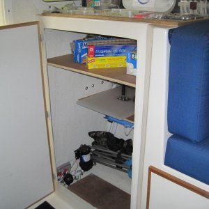 Storage locker accross from head. I usually keep an extra cooler or Waeco freezer there. The waste tank is under the drawer lower right.